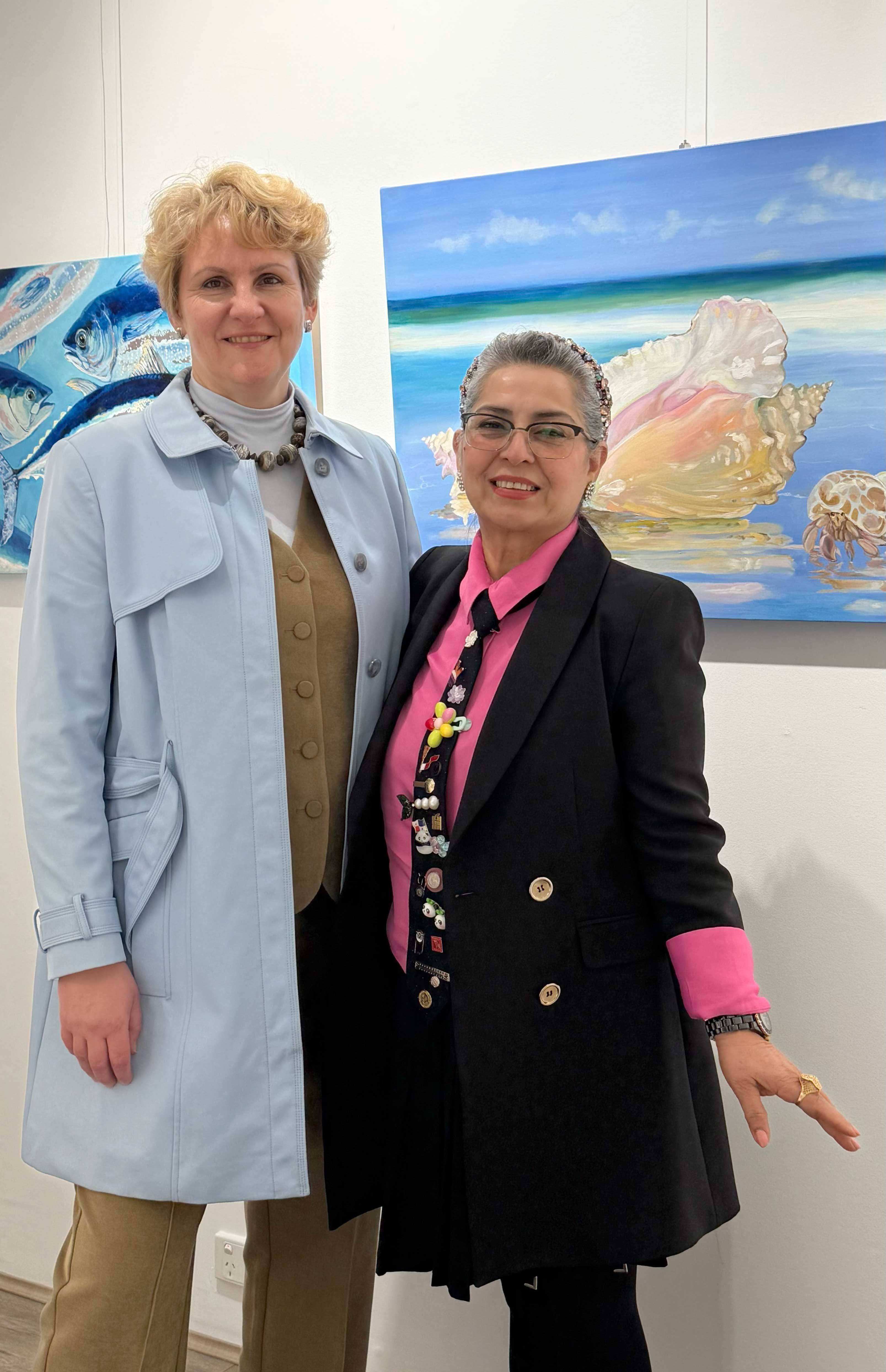 Australian landscape artist Tetiana Koldunenko at her Sydney exhibition, presenting original contemporary paintings