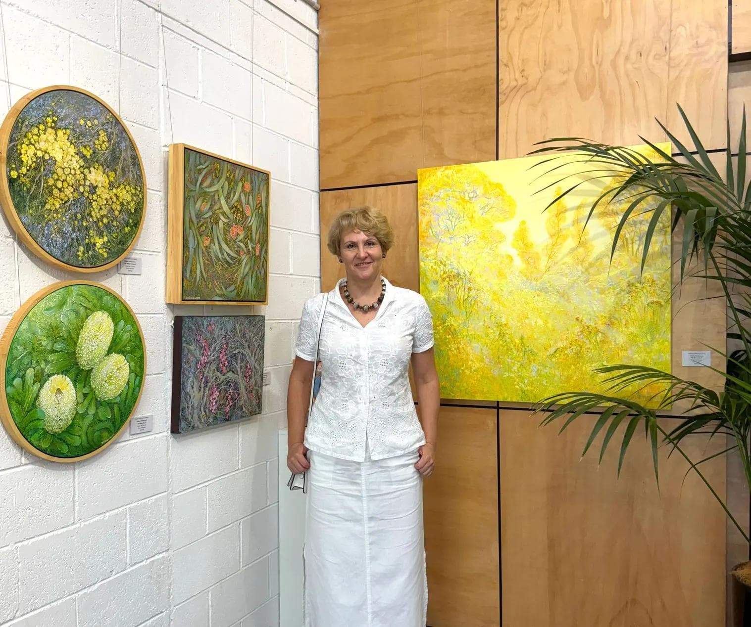 Australian landscape artist Tetiana Koldunenko at her Sydney exhibition, presenting original contemporary paintings