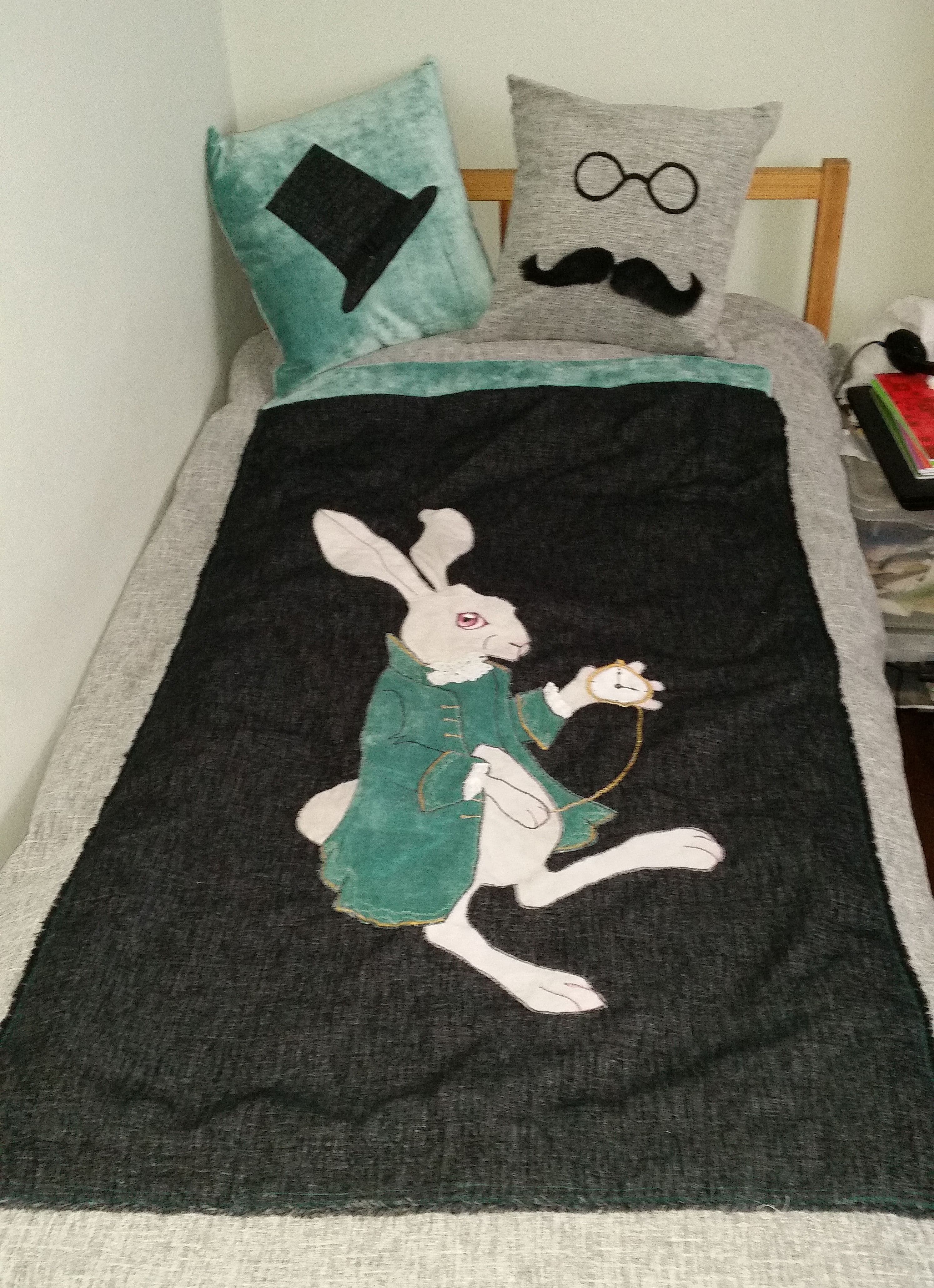 White rabbit bed cover. Grey and black background. Cushions with same theme decor